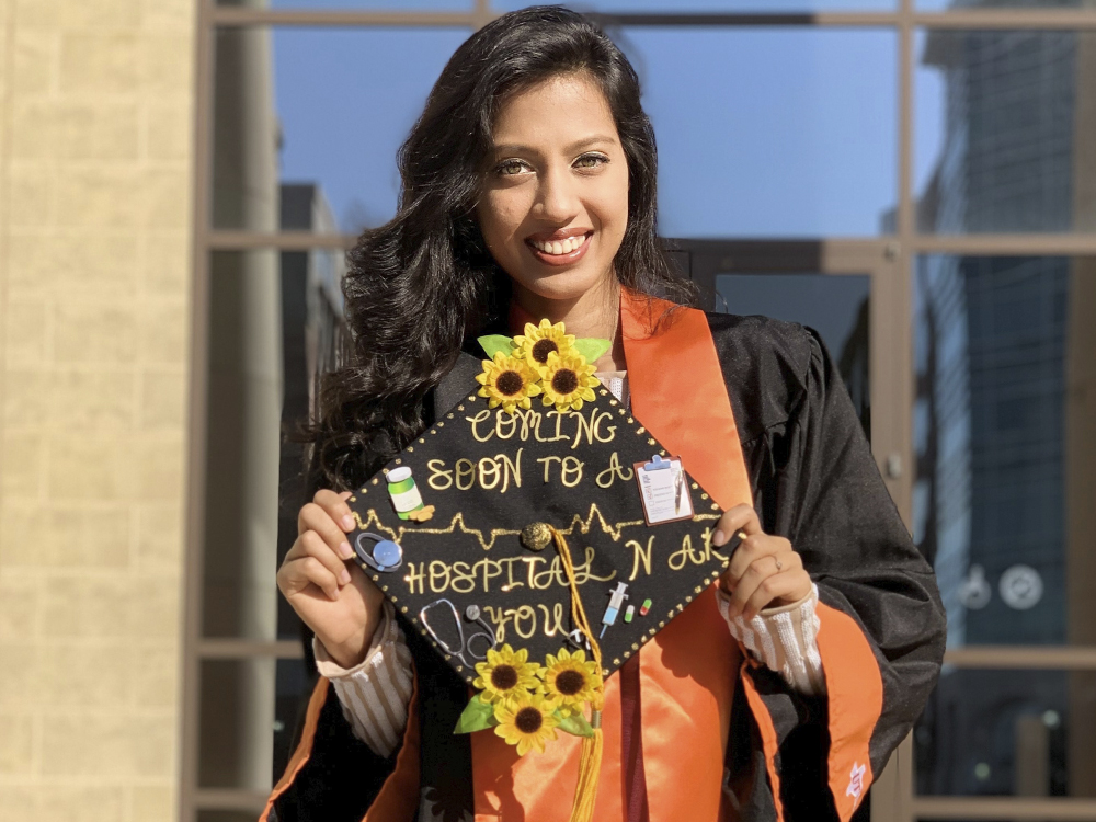 Woman holding up grad cap