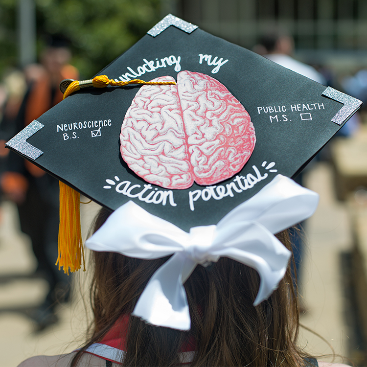 Cap that has a brain illustration that says unlocking action potential