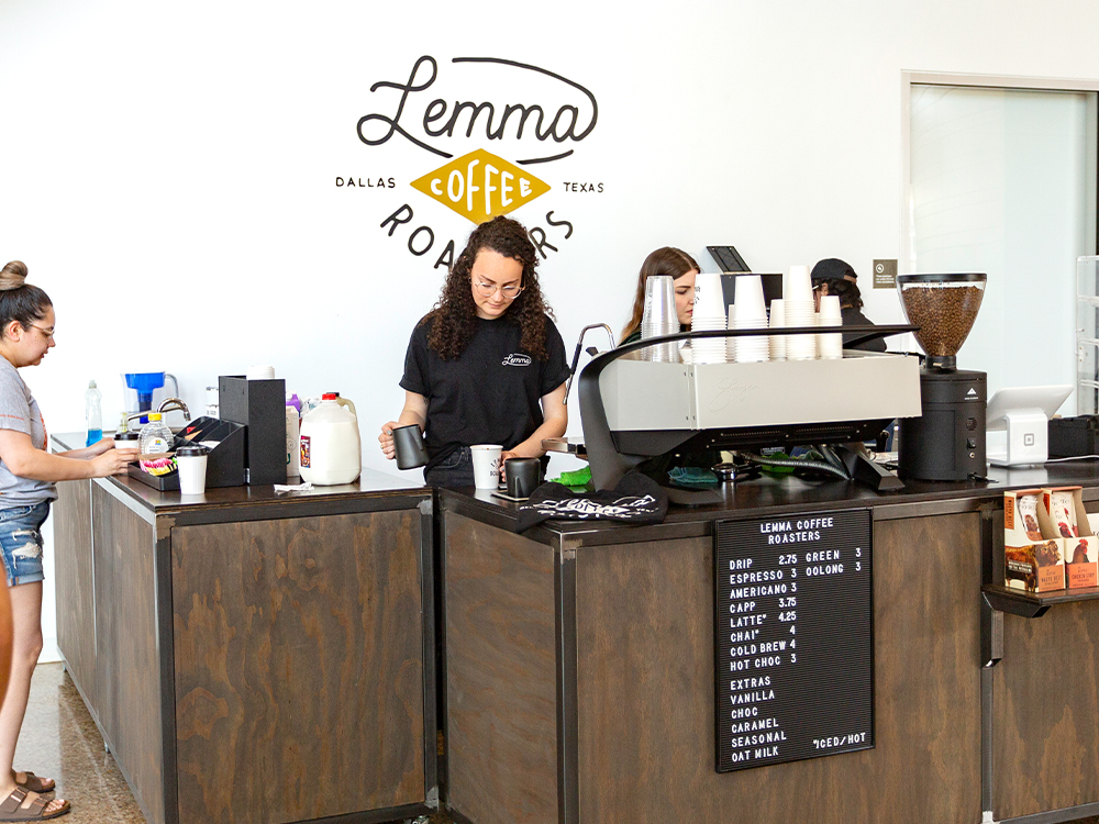 Working serving coffee at a business stand