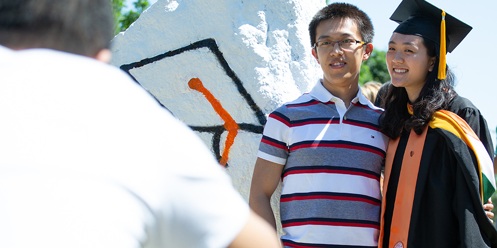 Rui Gue takes a picture at the spirit rocks with her husband.