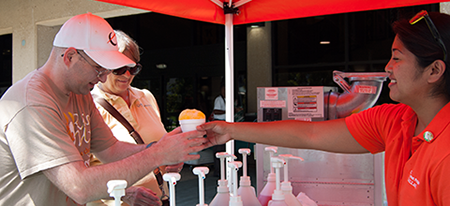 Justin and Mrs. Barnes enjoy snow cones served up by Karen Garcia.